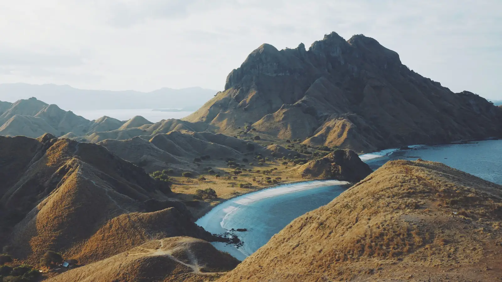 The curved bays and turquoise water of Padar Island in Komodo National Park seen from the ridge viewpoint